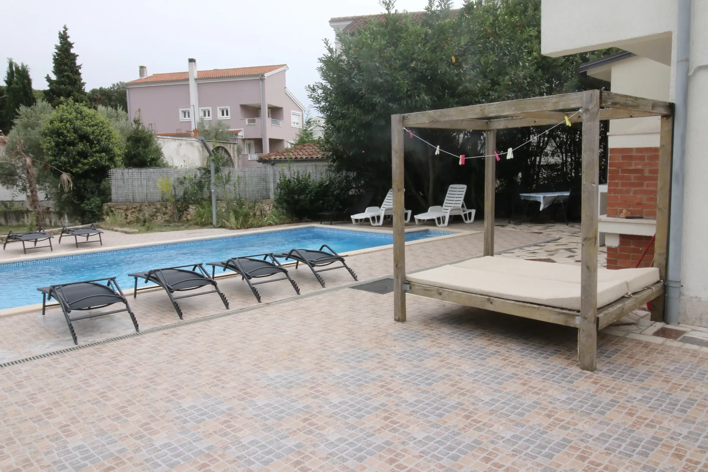 Canopied daybed on the pool deck of Villa Eucalyptus