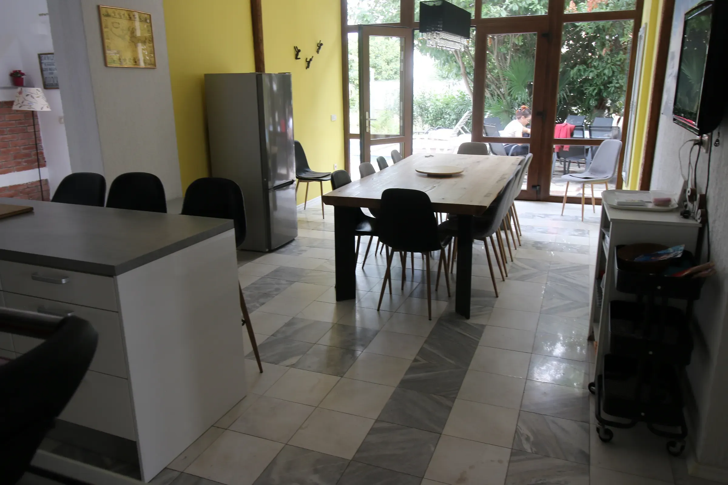 Open dining area and kitchen with doors to the garden