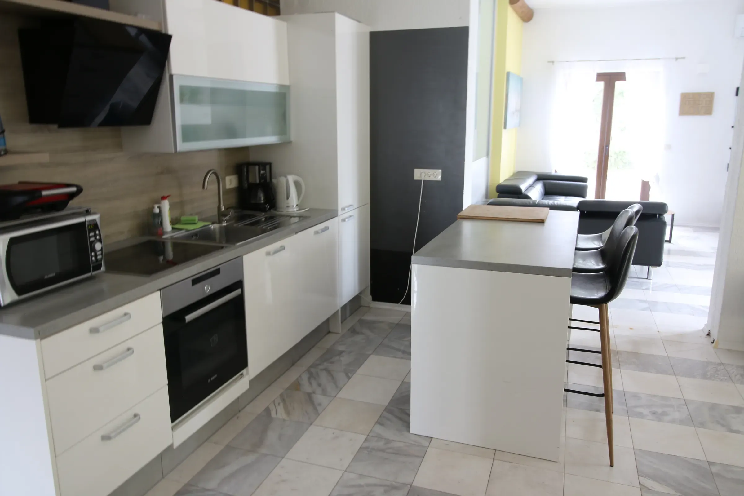 Fully equipped kitchen with a breakfast island and bar stools