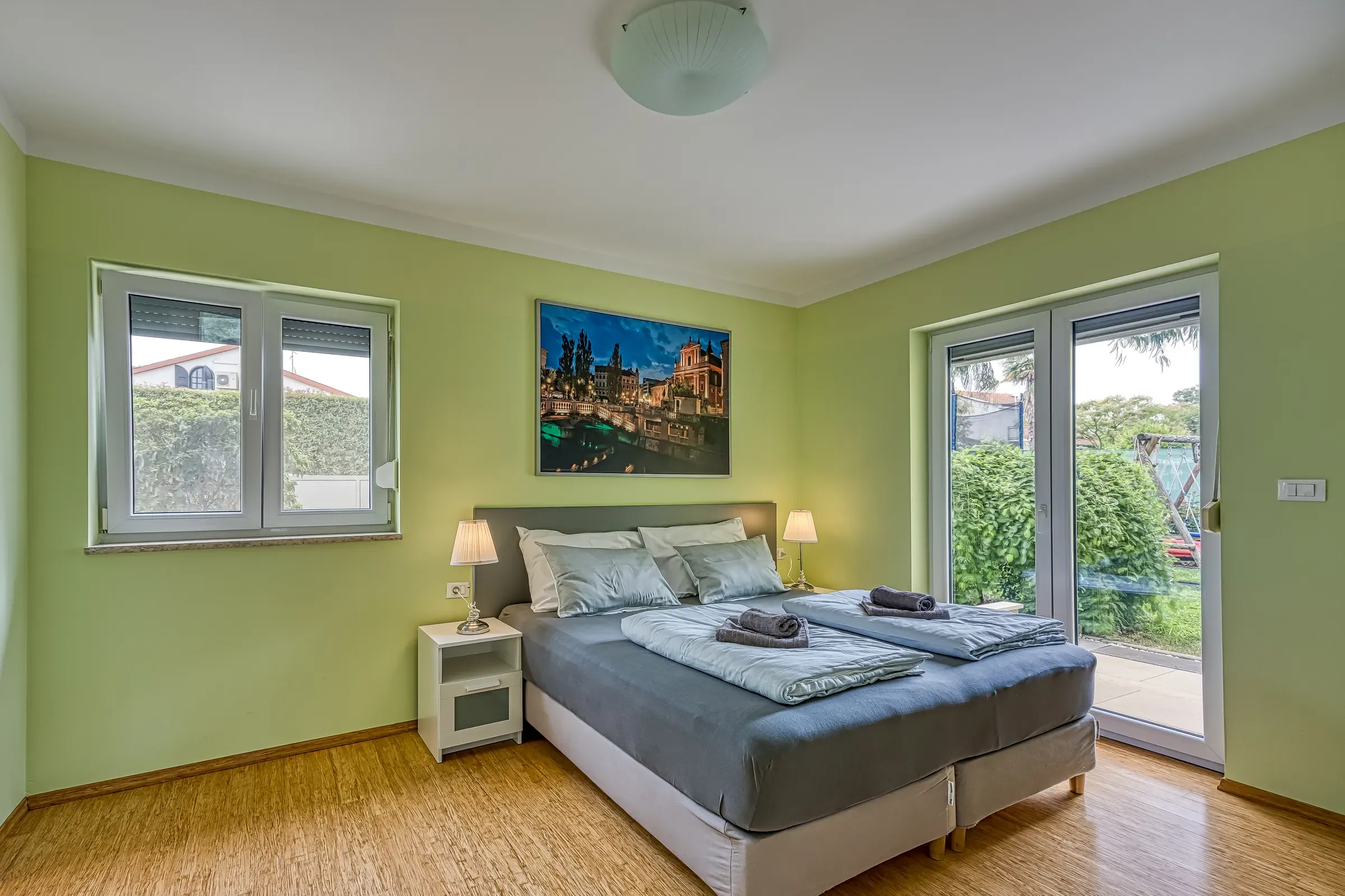 Ground-floor double bedroom with doors opening to the garden