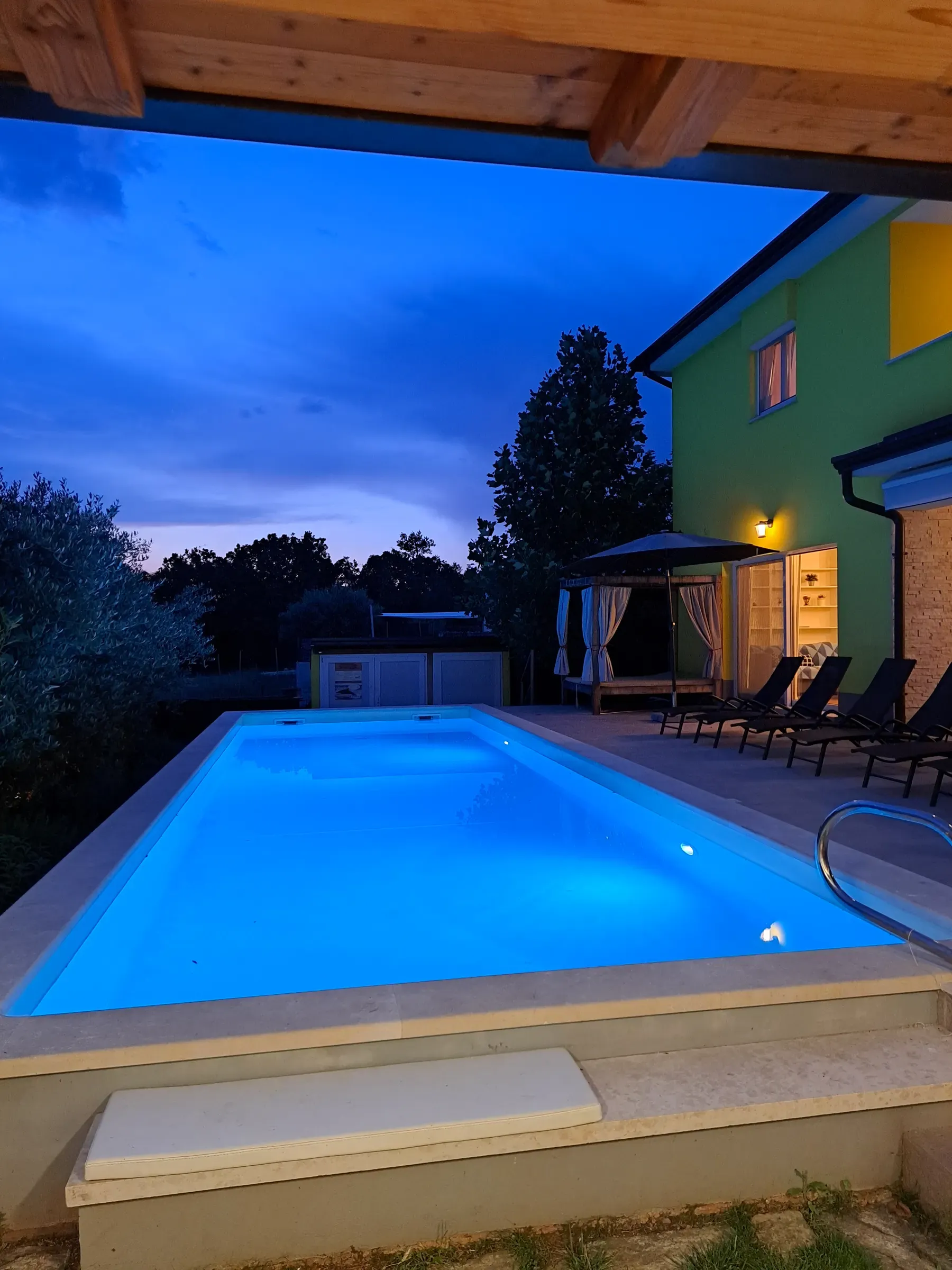 Evening light over the XL pool and garden at dusk